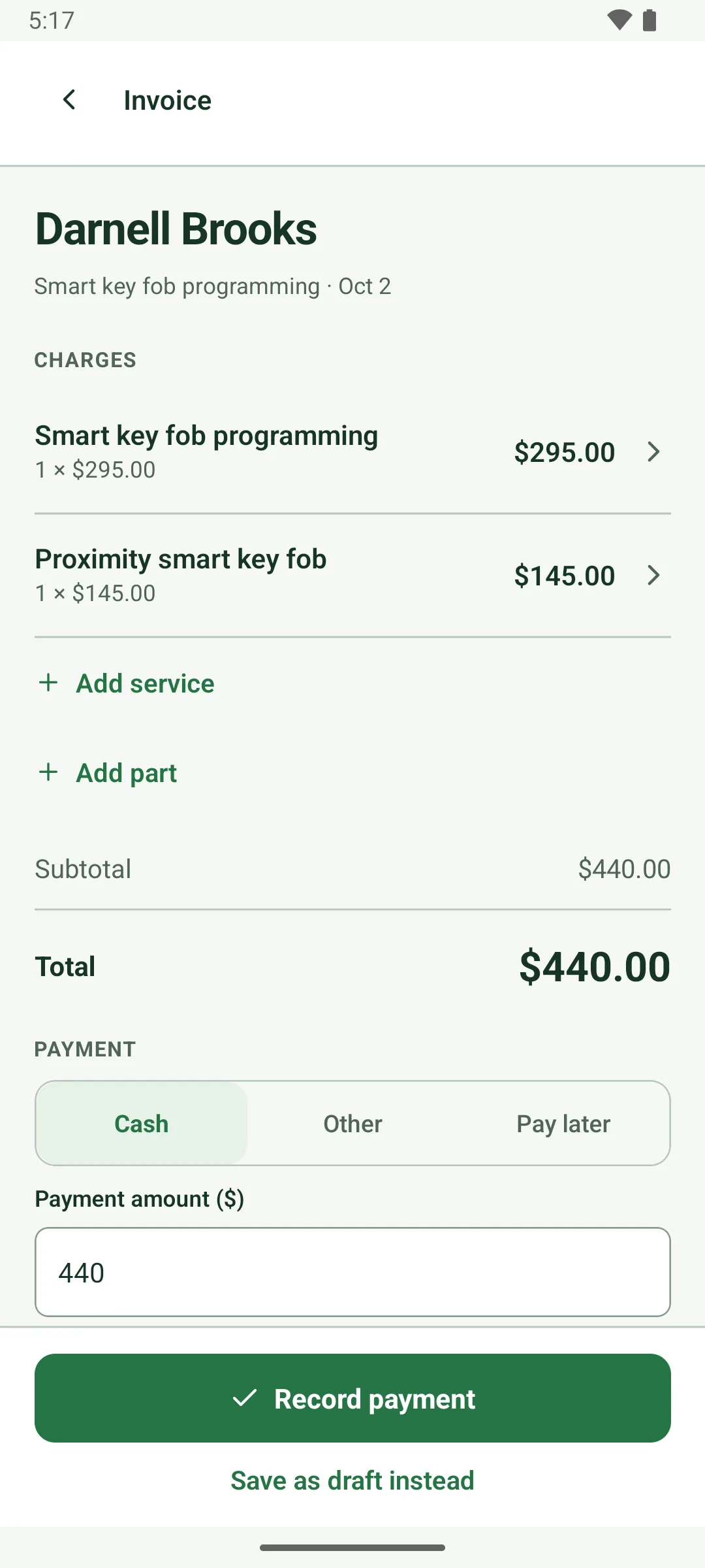 An invoice for Darnell Brooks prepared before the job is finished: smart key fob programming $295.00 and a proximity smart key fob $145.00, total $440.00, payment Cash with amount 440, and Record payment or Save as draft instead.